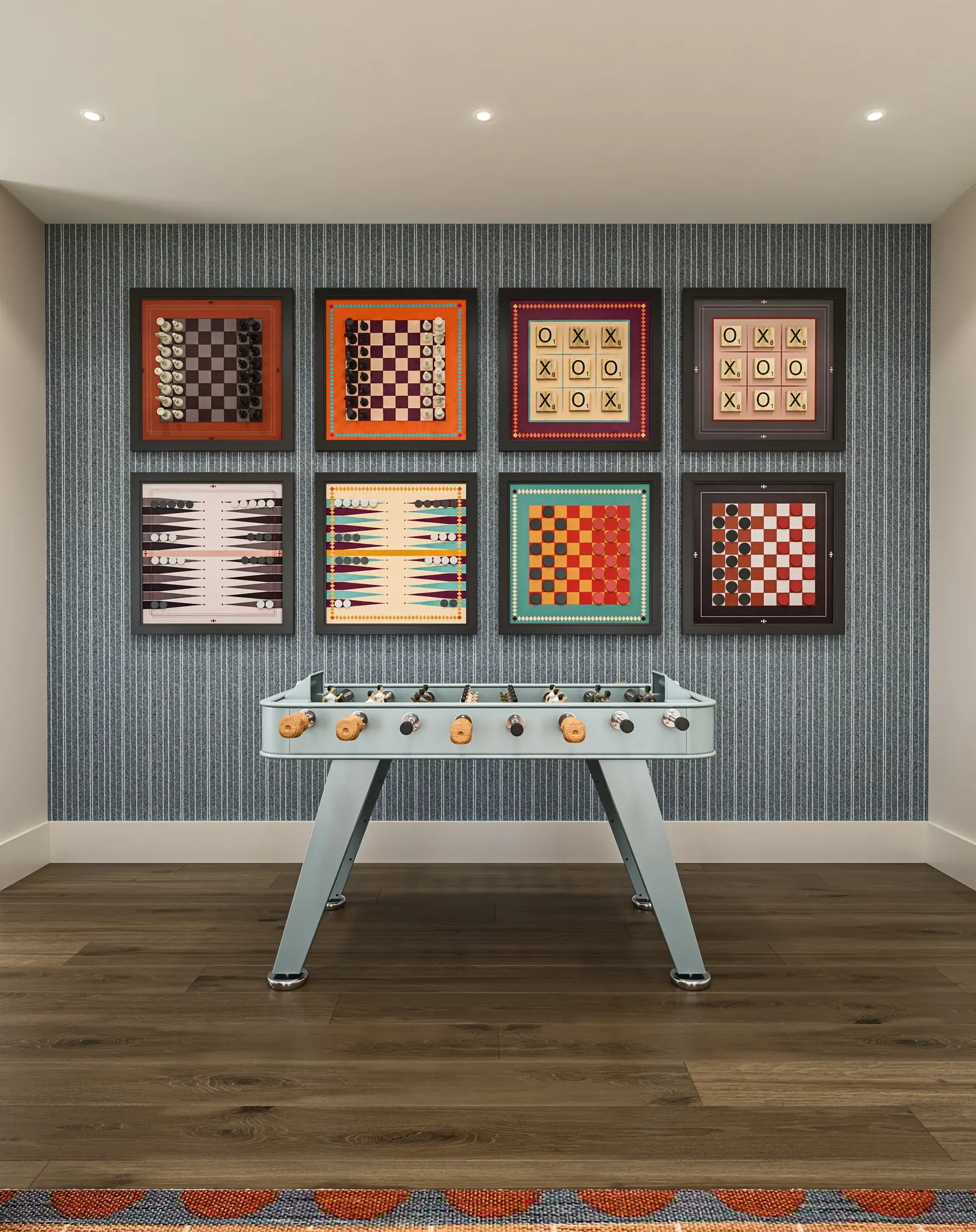 A wall of framed game boards above a foosball table in the game lounge